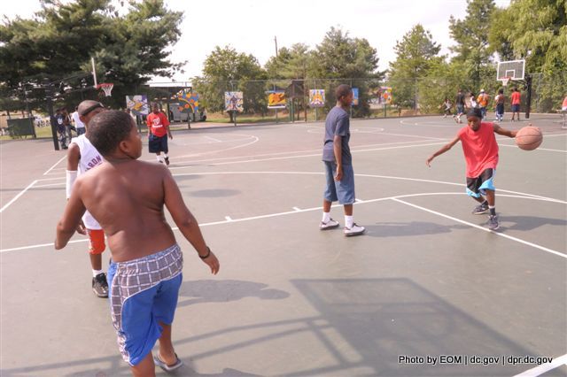 a couple of s playing basketball with each other