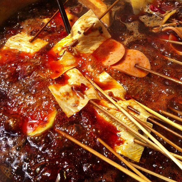 chopsticks in a pot full of some food