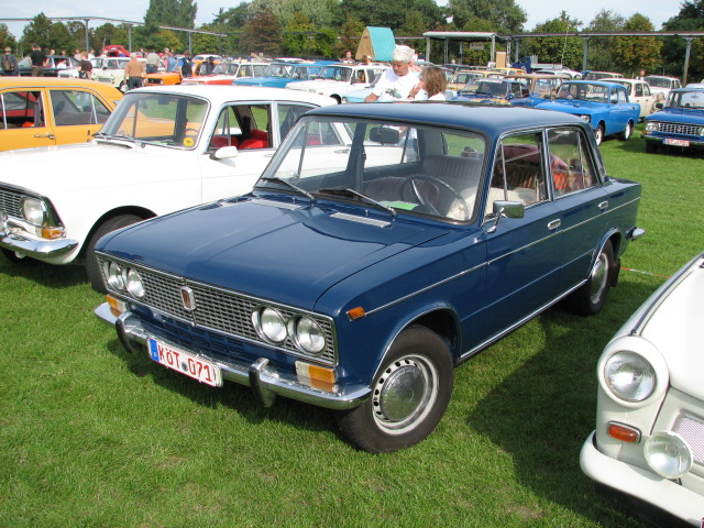 several old cars parked on the grass of an outdoor event
