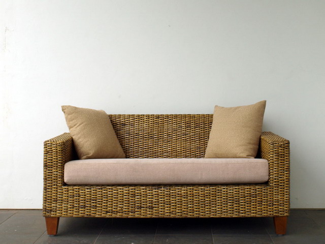 a couch with pillows sitting on a floor
