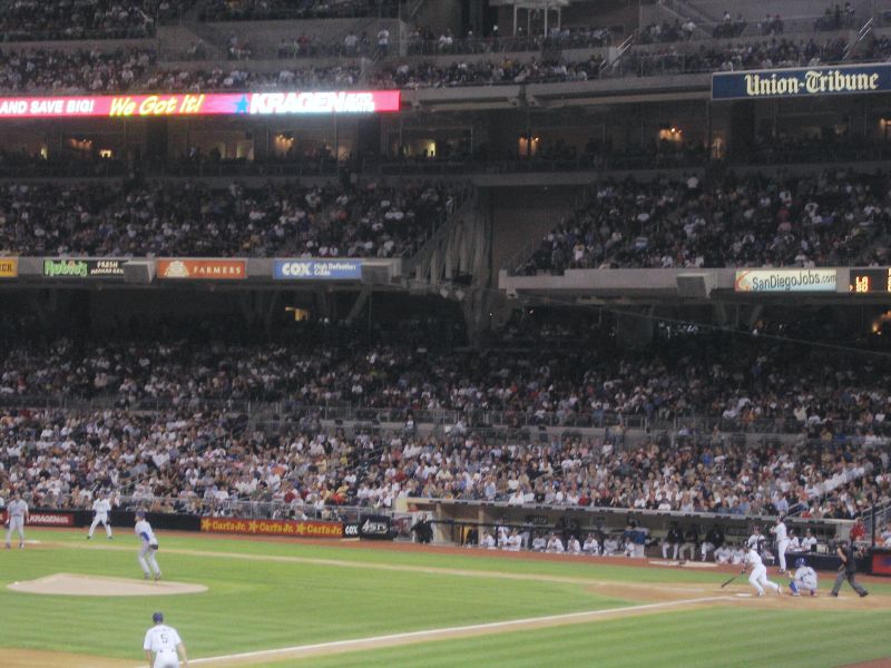 a baseball game in progress on the field with people watching