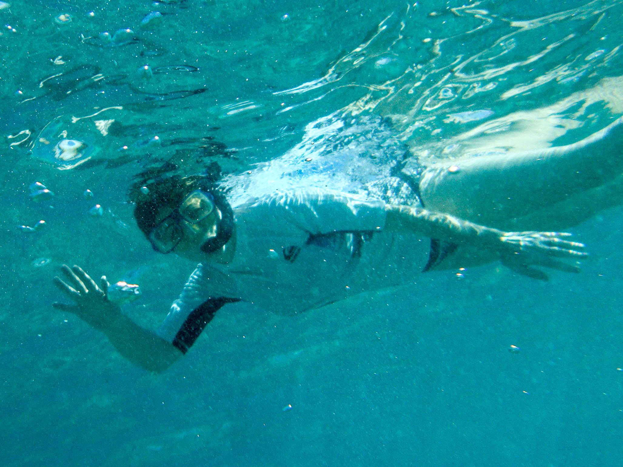 a man swimming in the ocean wearing a mask