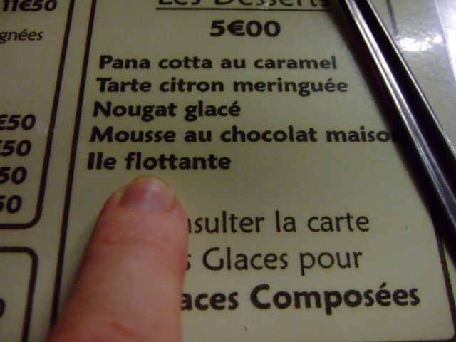 a close up of a person pointing at menu