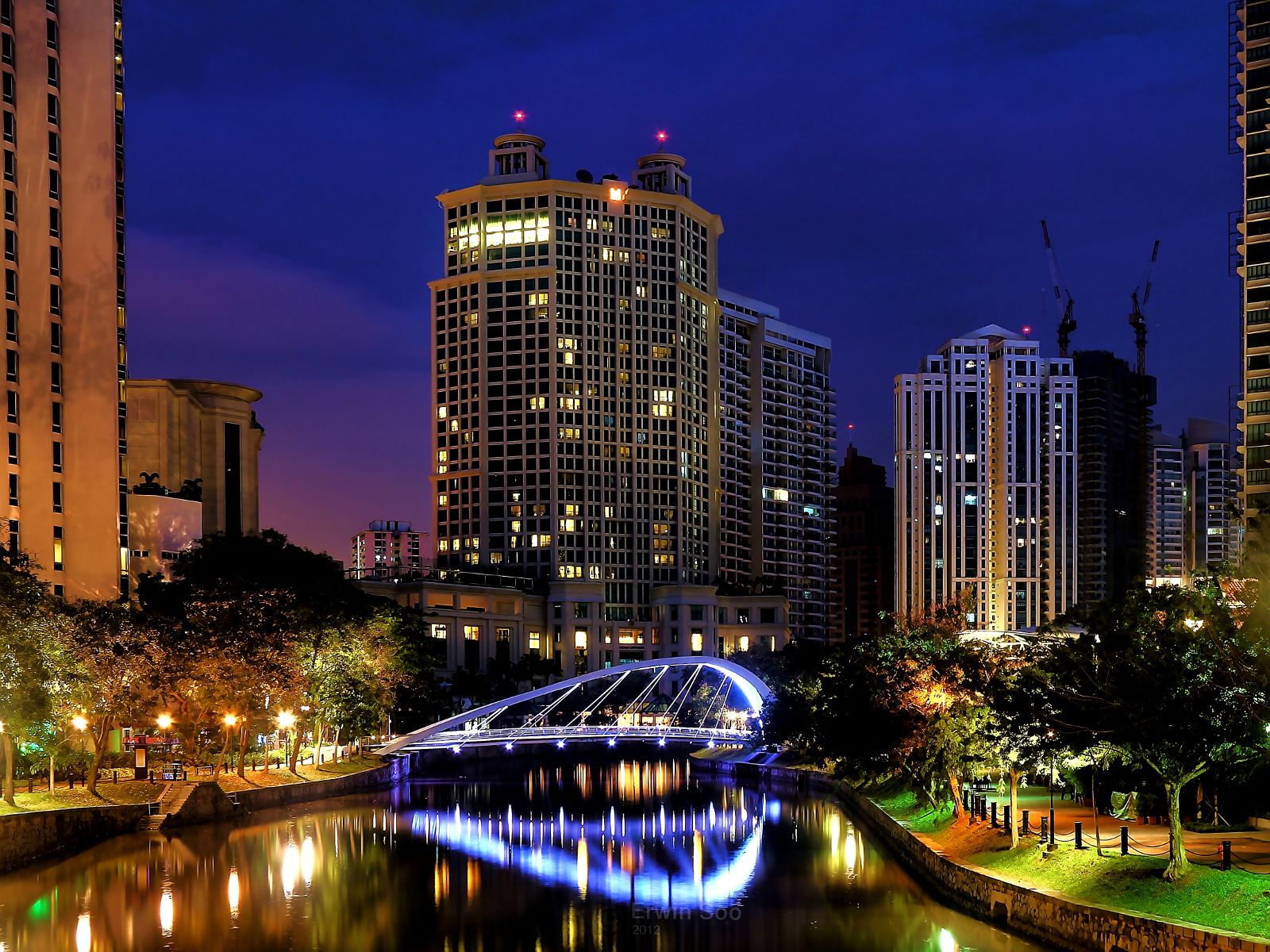 city skyline over a waterway in a river at night