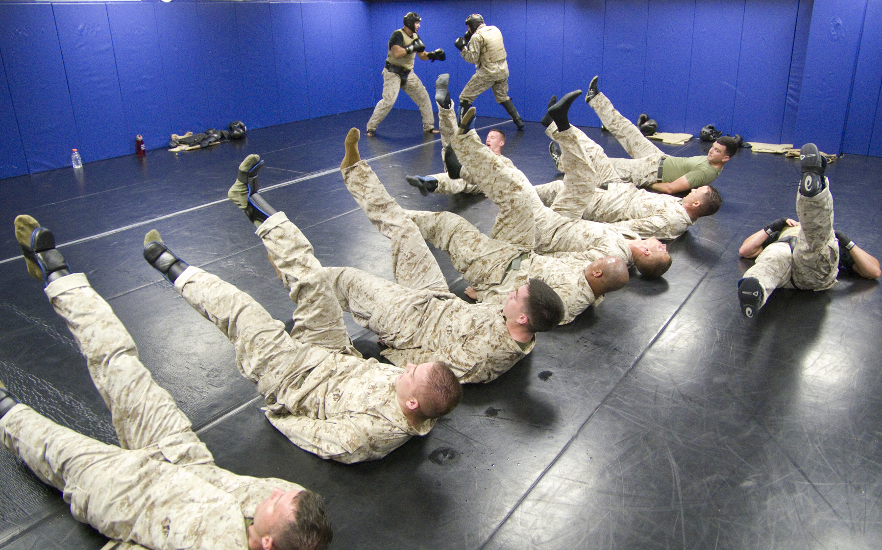 a group of men in army fatigues doing tricks