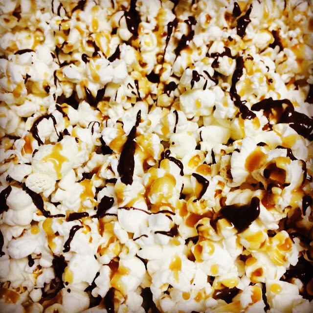 the popcorn is covered with melted chocolate and peanuts