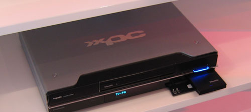 a dvd player sits on top of a shelf