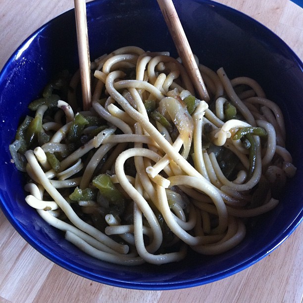 a bowl of spaghetti with various vegetables on it