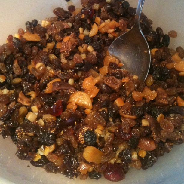 a bowl filled with a mixture of raisins and nuts
