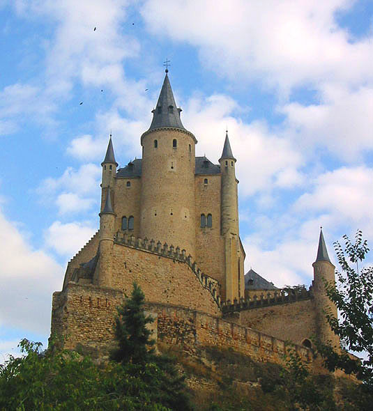 a castle like building sitting atop the side of a hill