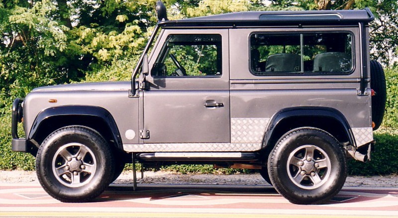 a black and gray vehicle parked near trees