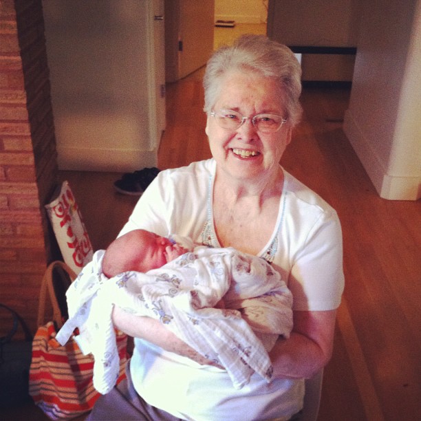 an old woman is holding her baby