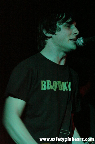 young man holding a black microphone in his mouth