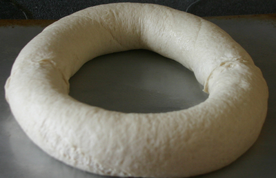 a round white pillow is on a metal surface
