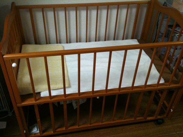 a wooden crib is sitting in a room