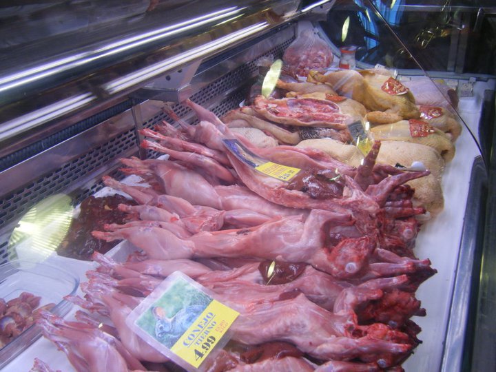 an assortment of meat on a display case