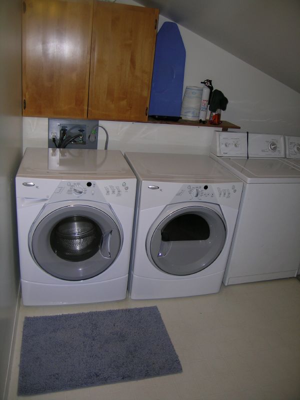 a laundry room with washers and dryer in the same area