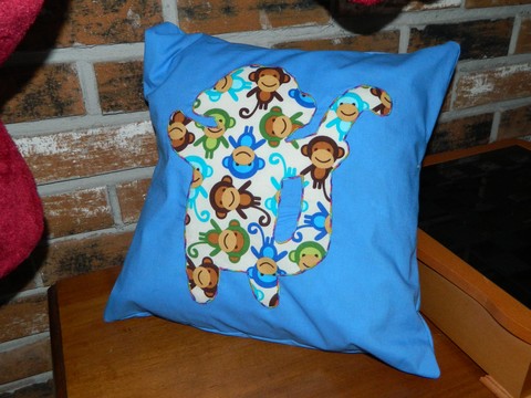 a decorative pillow is shown with monkeys on it