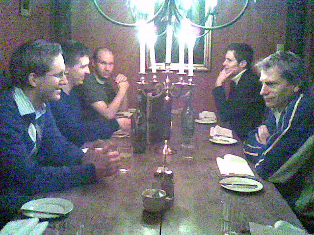group of people at table with candles on it