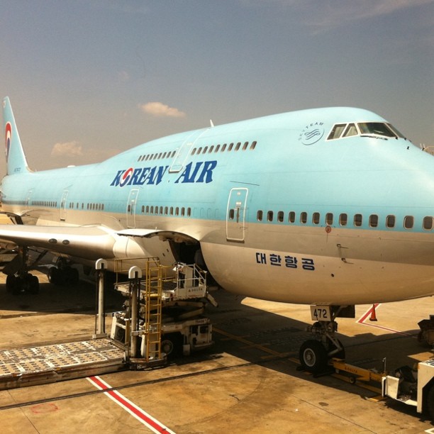 a plane being loaded onto an airport cart