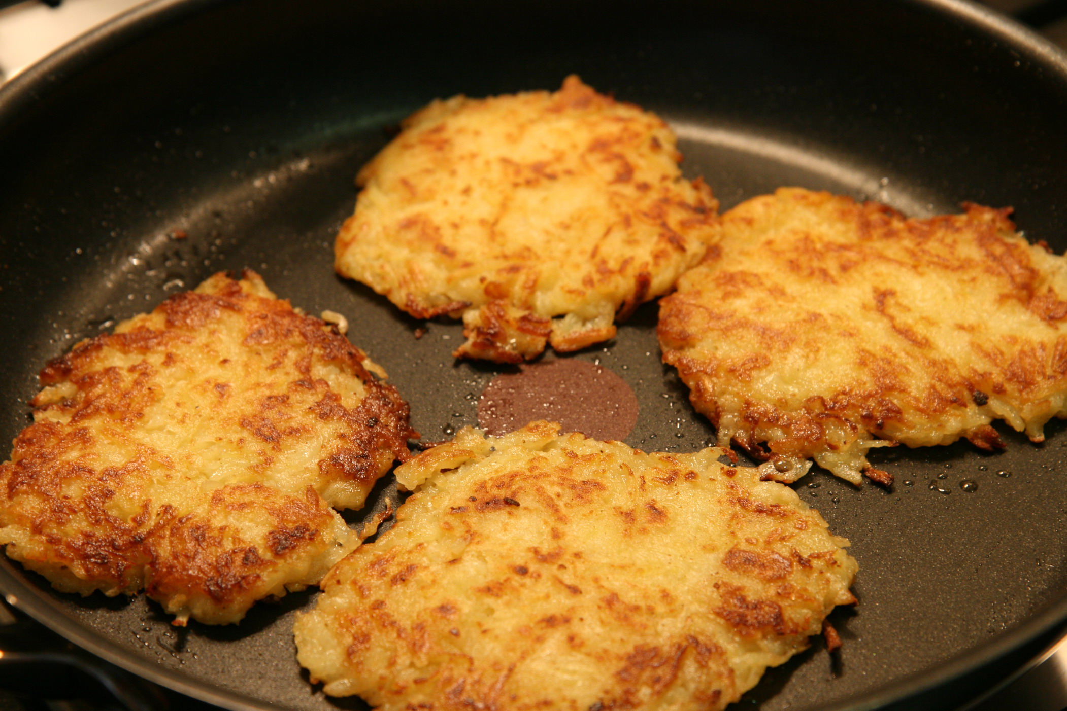 the pan is filled with four fried cakes