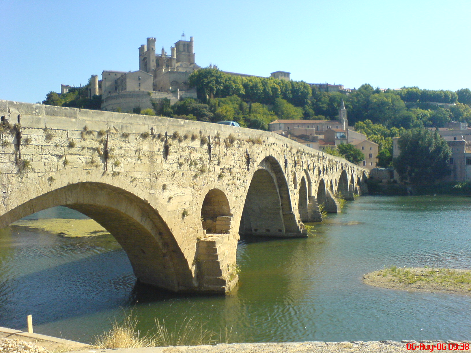 a stone bridge that runs over a lake