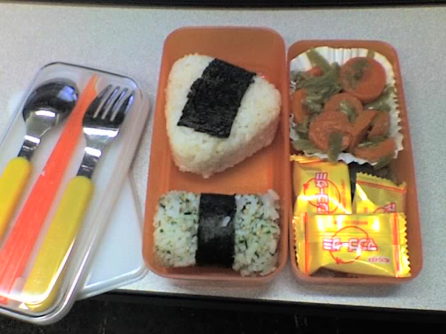 a small lunch box with rice, meat and veggies