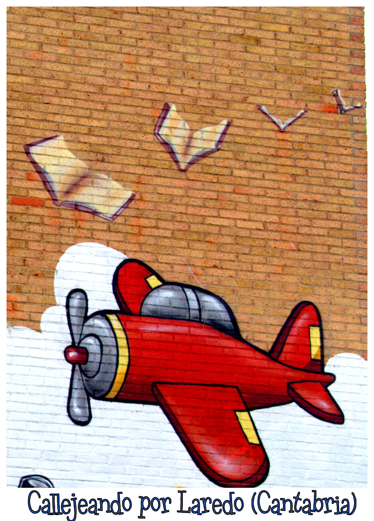 graffiti of a red plane in front of a brick wall