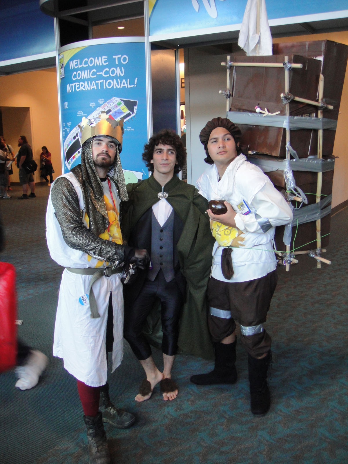 three men standing next to each other wearing costumes