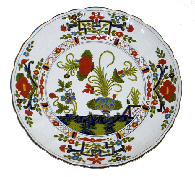 a plate with designs in oriental art depicting horses and flowers