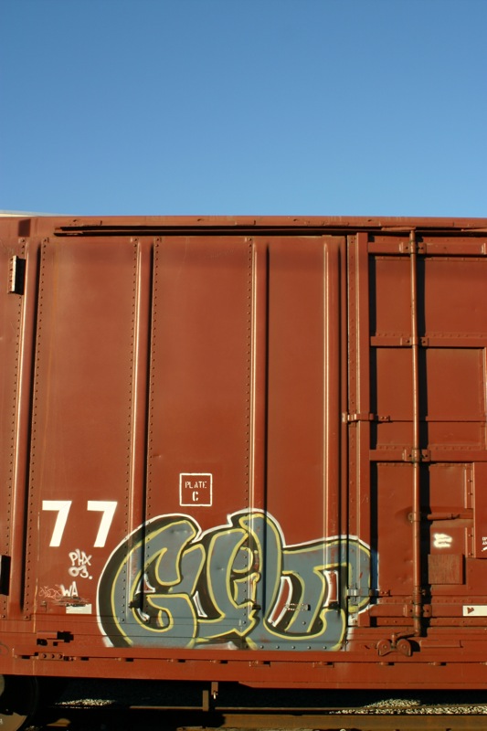an empty box car has graffiti on it