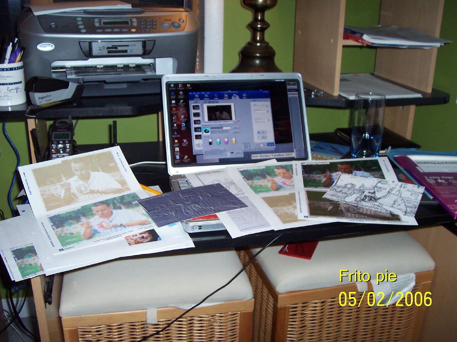 the laptop and various papers on the table are piled up
