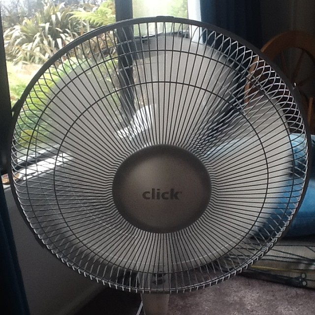 an outdoor fan in front of a window with the words click on it