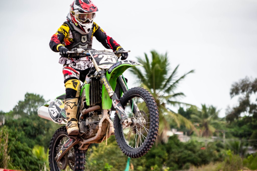 a man riding a dirt bike over some dirt