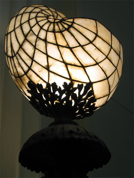 the top of an unusual lamp with many layers of stained glass