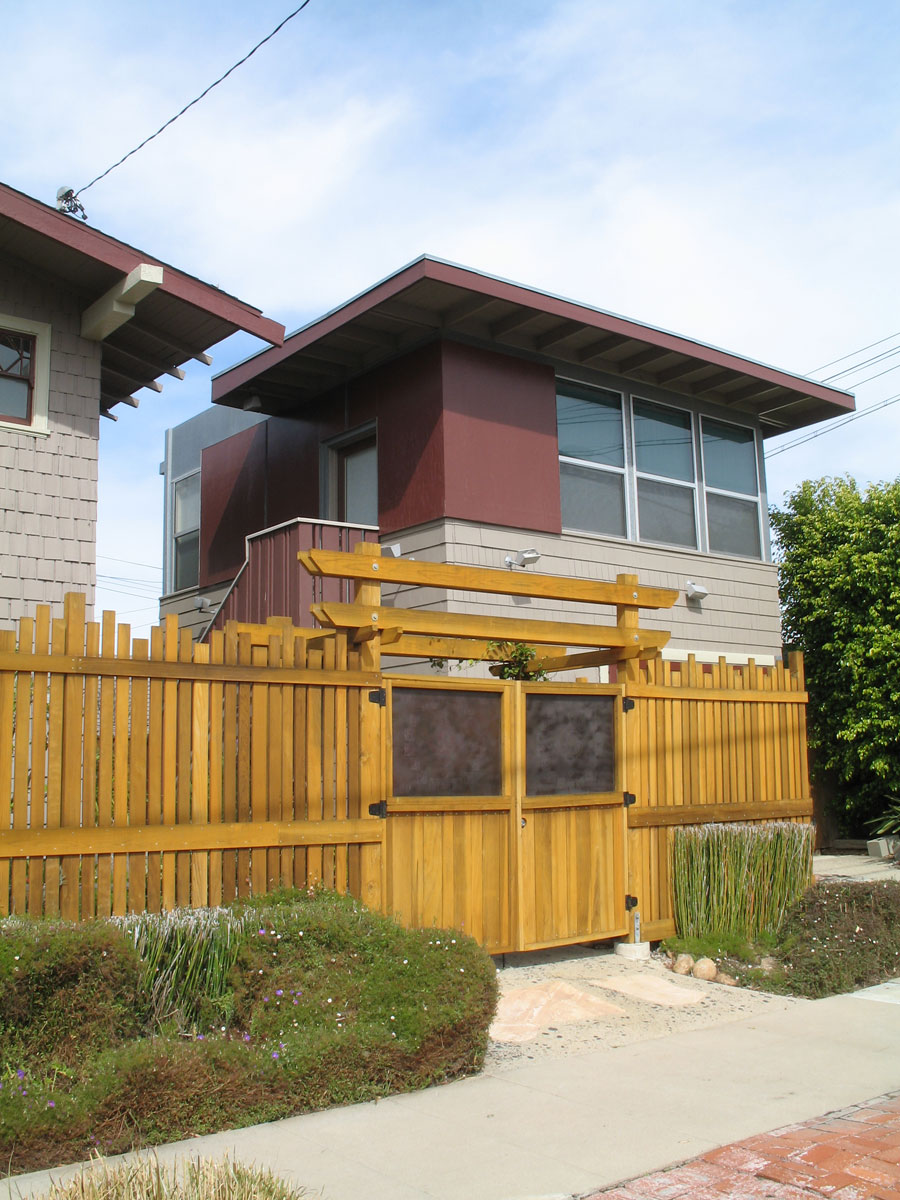 the two tall buildings are surrounded by wooden fences