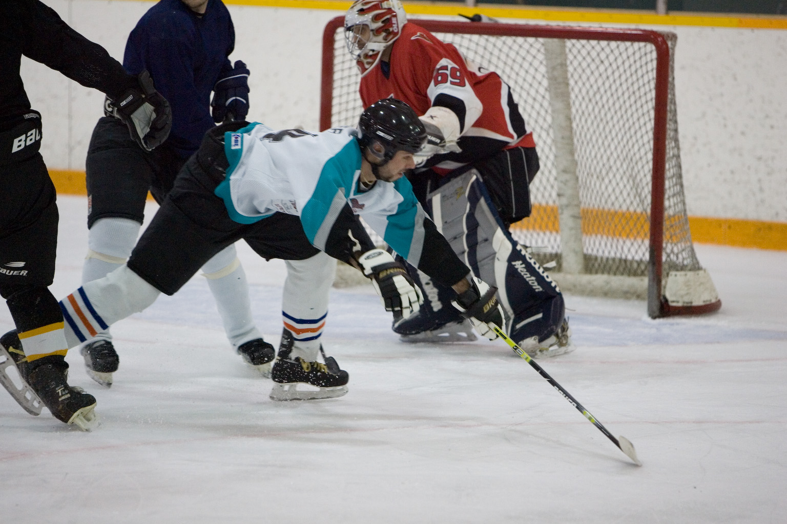 three hockey players in various action on the ice