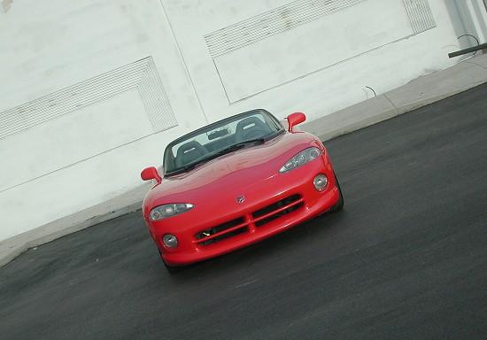 a red sports car driving down a street