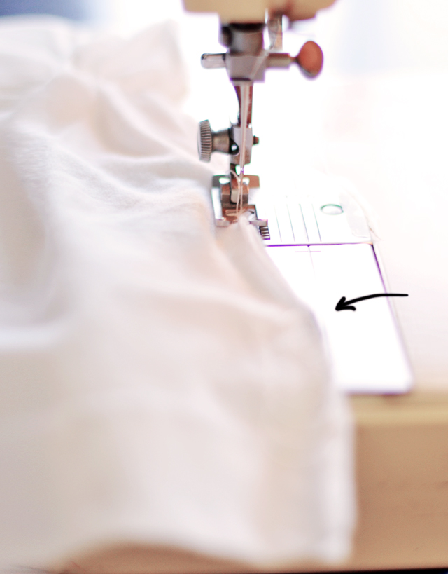 the sewing machine stitchs through the fabric to make a hand - made pillow