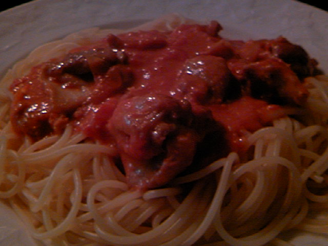 a bowl of spaghetti and meat sauce with sauce on top