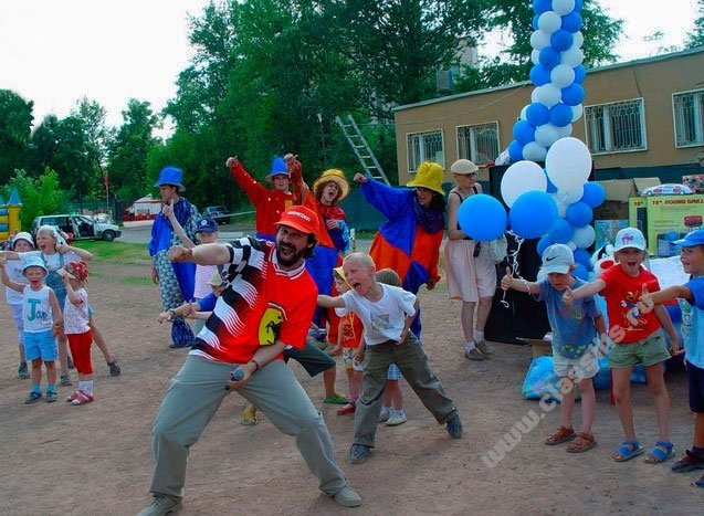 a group of young people standing around a child