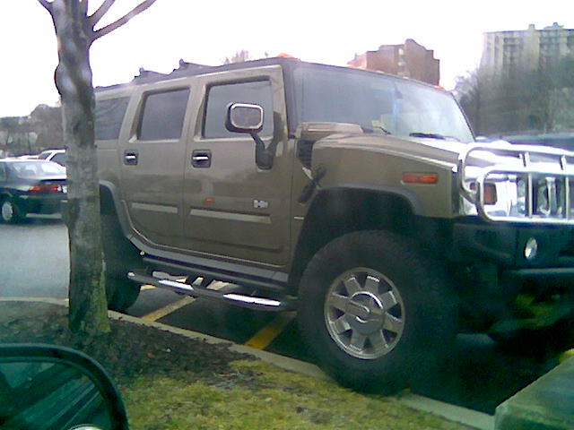 a gray hummer truck is parked in a parking lot