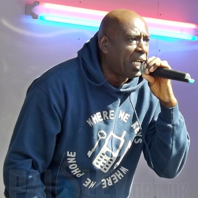 a man with a microphone and a sweatshirt on