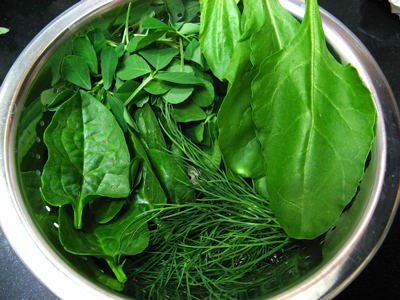 green leaves are being cooked in a pot of water