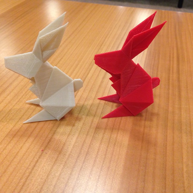 two origami animals sitting on top of a table