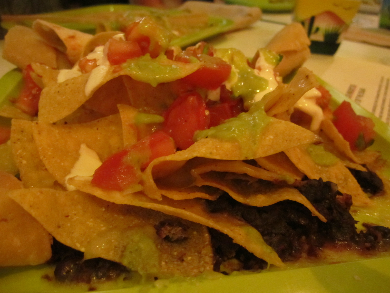 chips and tacos on a plate with a drink on the side