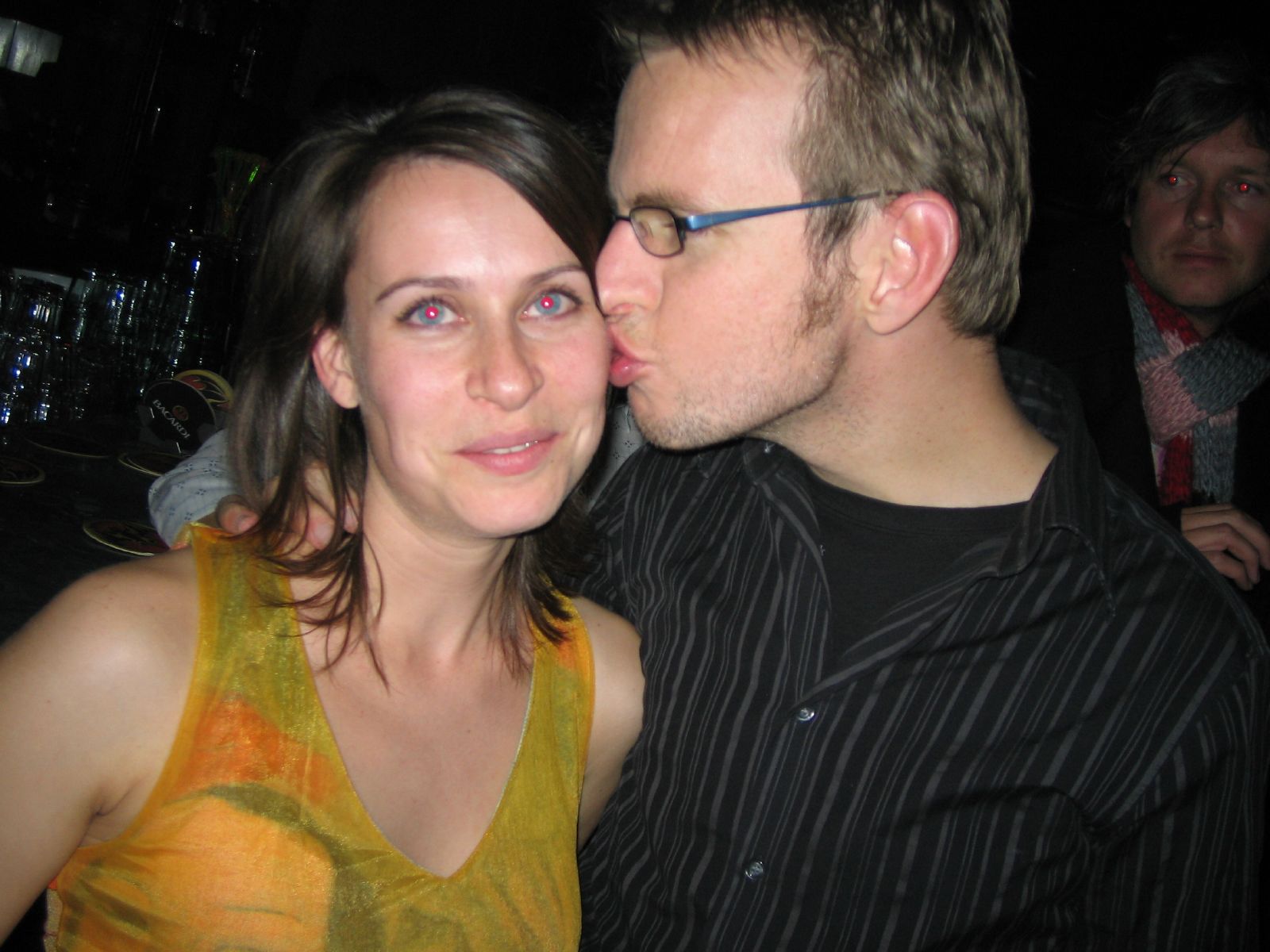there is a young woman with glasses kissing the cheek of an old man