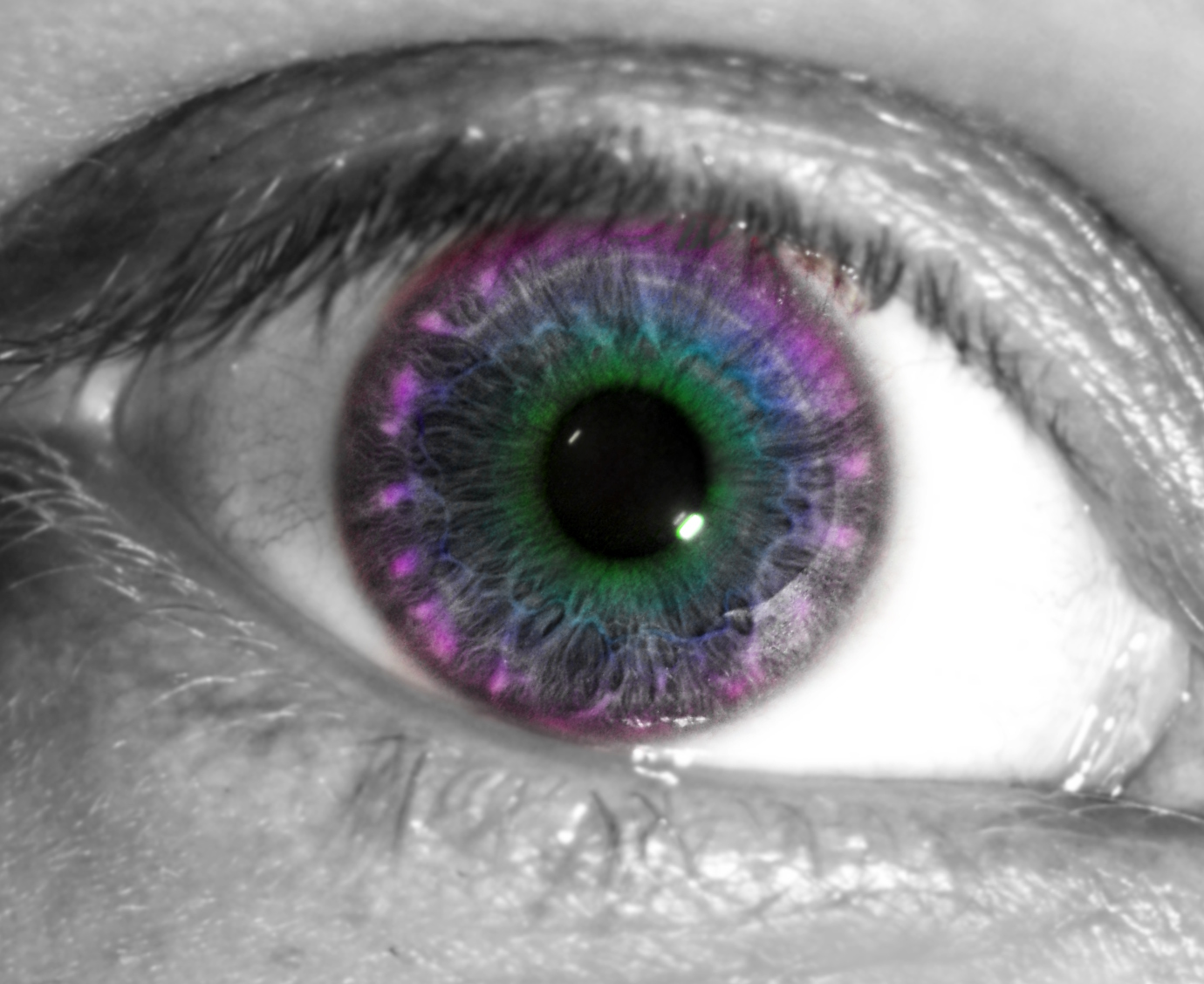 an eye with bright green and blue colors