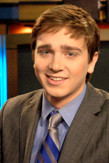 young man in gray suit with tie and blue shirt