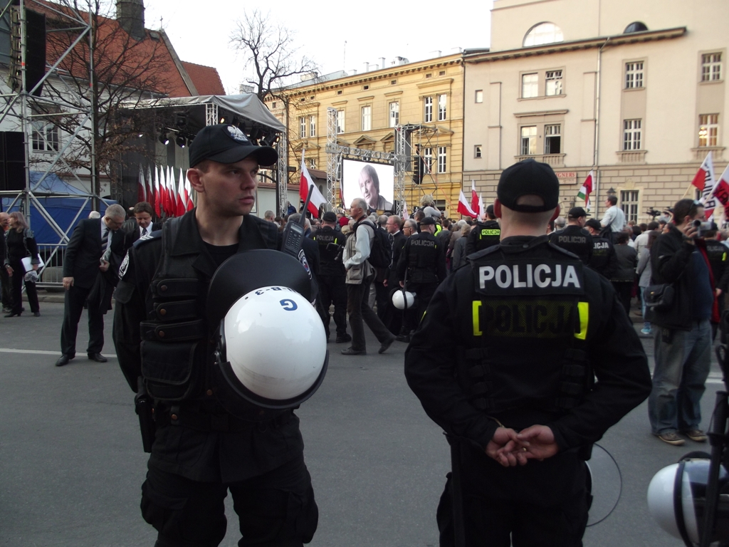 men in police uniforms hold helmets and protest flags